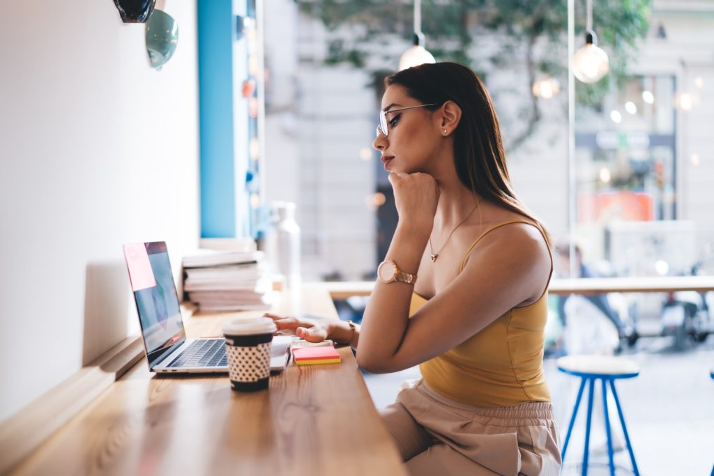 Skilled hipster girl connecting to public 4g wireless internet for browsing social media